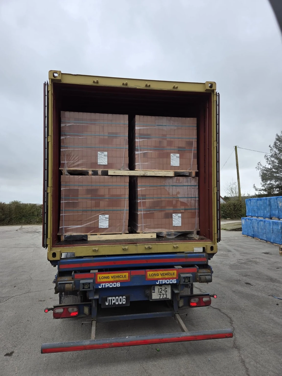 Palletised goods inside an open container.