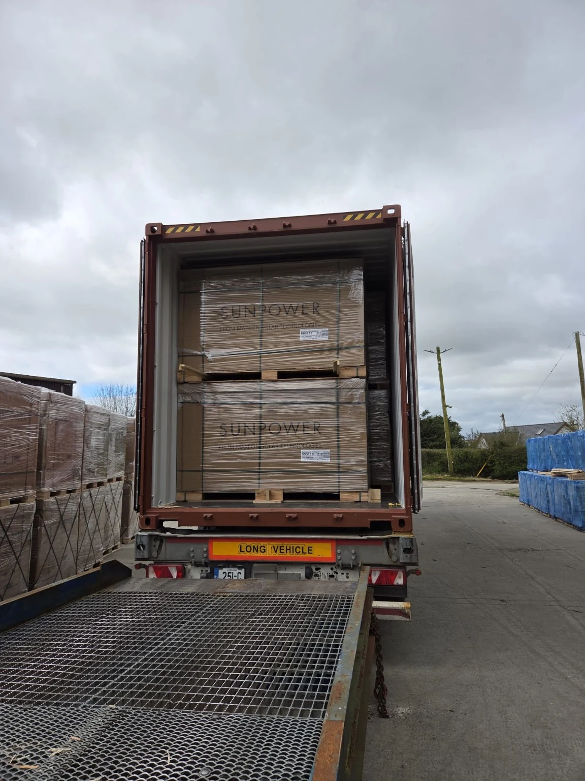 An open container with palletised goods and a receiving ramp.