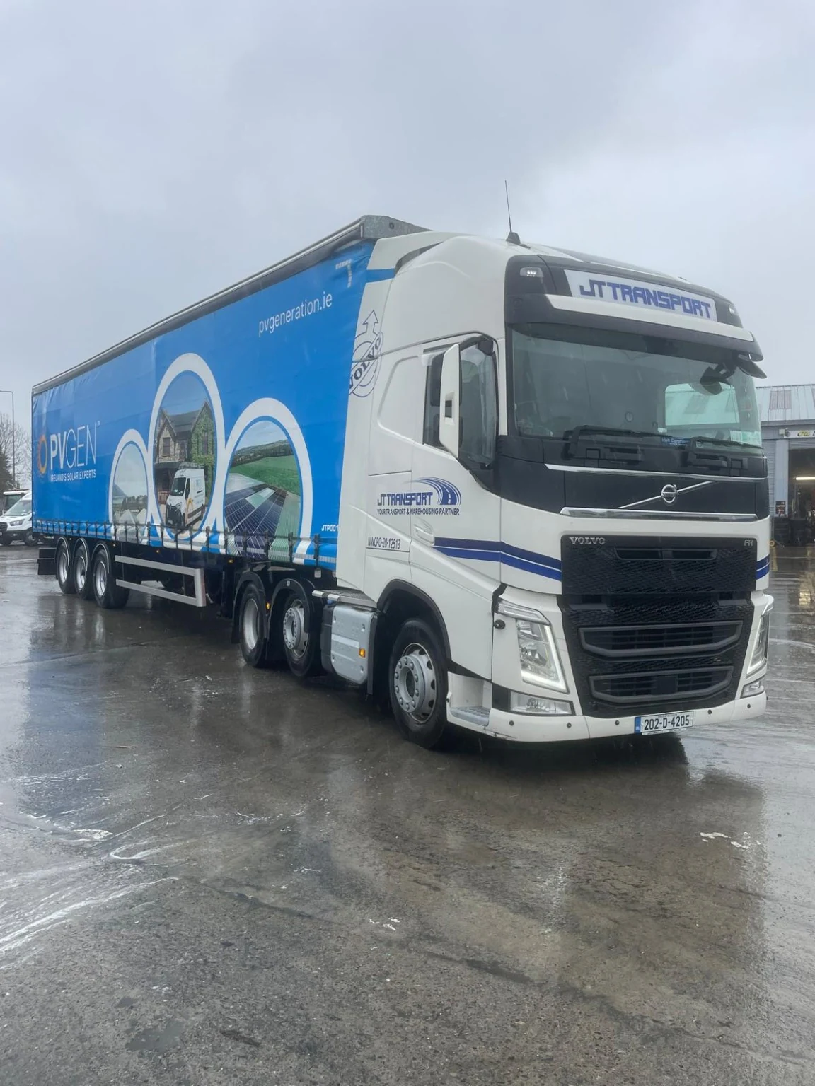 JT tractor unit with a customer-branded curtainsider trailer.