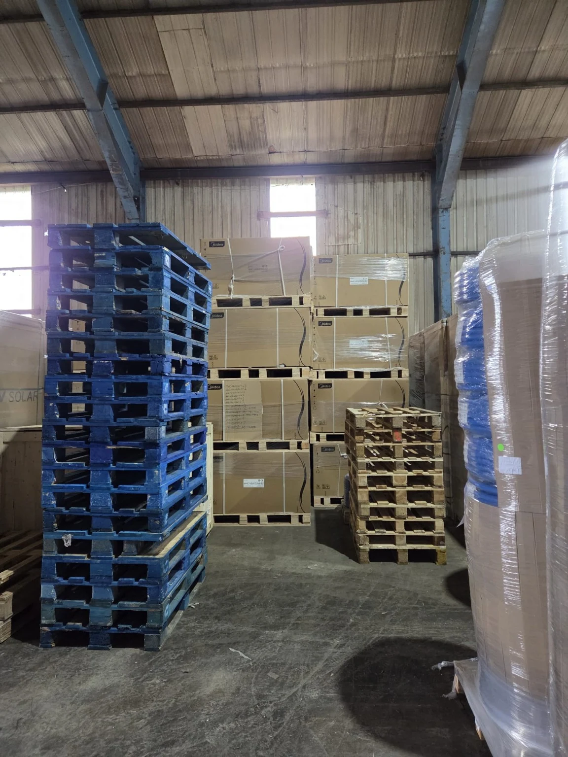 Stored goods and pallet stacks inside the warehouse.